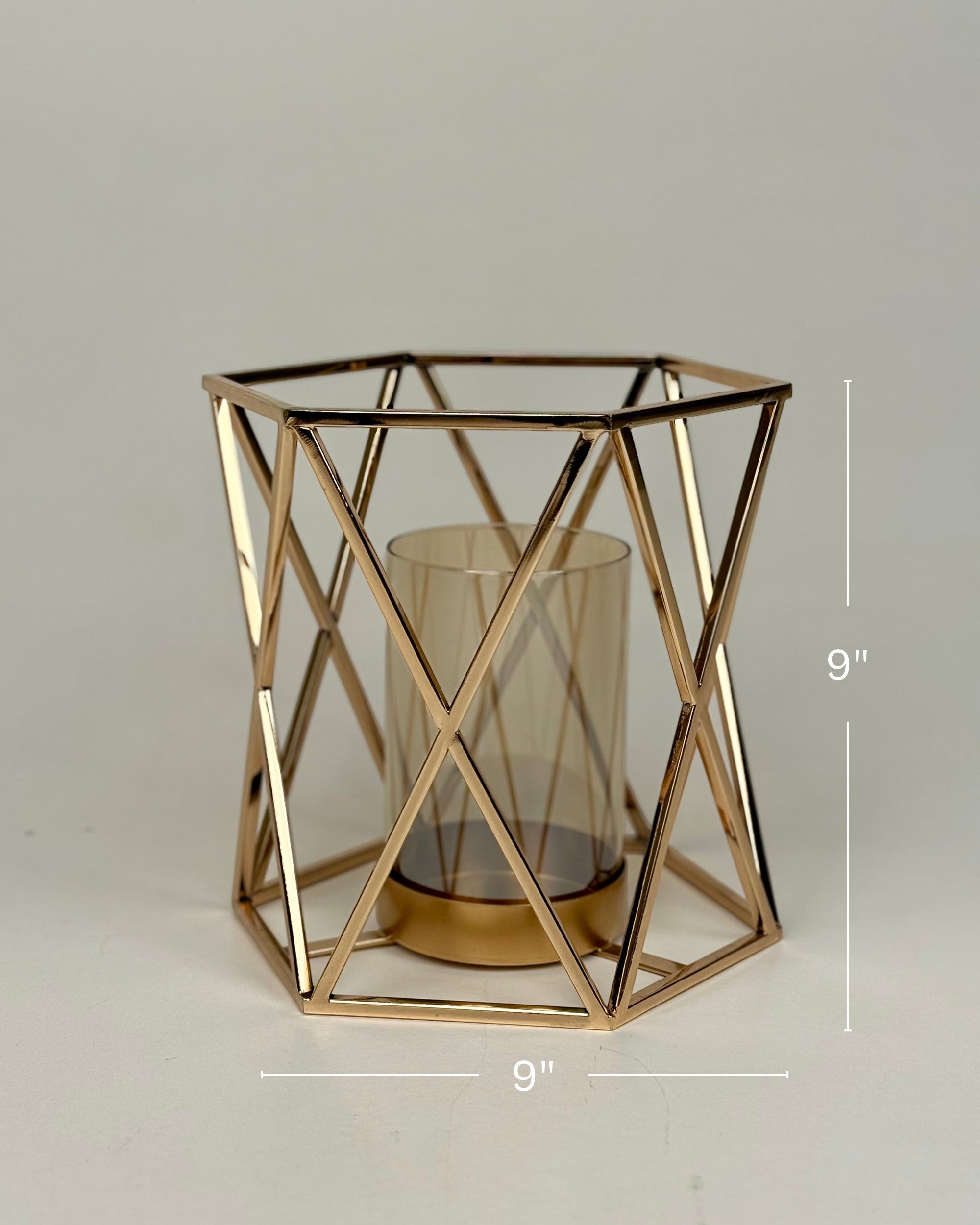 High Objects Gilded Prism Candle Stand with gold-finished geometric frame and amber glass holder.