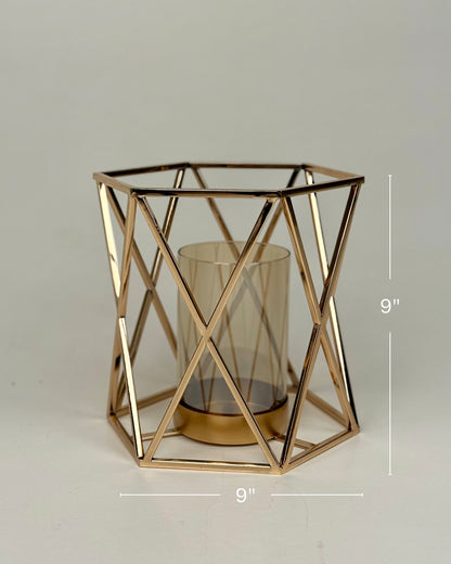 High Objects Gilded Prism Candle Stand with gold-finished geometric frame and amber glass holder.