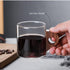 High Objects EchoBrew clear borosilicate glass cup with wooden handle, filled with dark beverage.