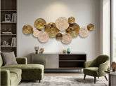 High Objects decorative wall art featuring overlapping gold metal and textured beige circular discs in a living room.