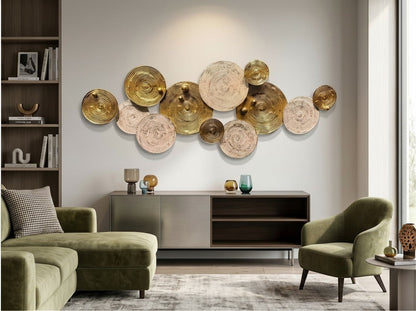 High Objects decorative wall art featuring overlapping gold metal and textured beige circular discs in a living room.