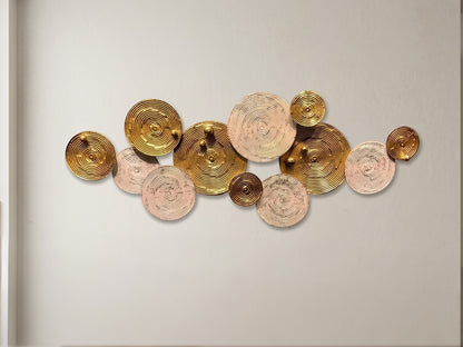 High Objects modern wall art featuring a cluster of metallic gold and textured beige circular discs on a wall.