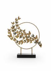 High Objects gold metal butterfly branch sculpture with circular frame and black base.