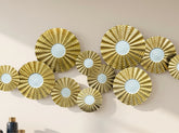 High Objects gold metallic wall art featuring a cluster of textured circular discs with white concentric centers.