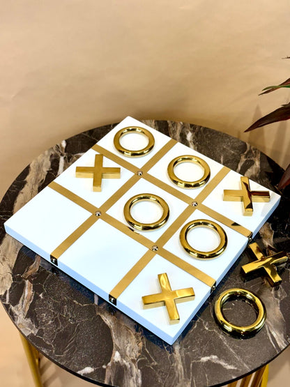 High Objects Gold Tic-Tac-Toe Set with white board and gold-tone iron pieces. Modern luxury decor.