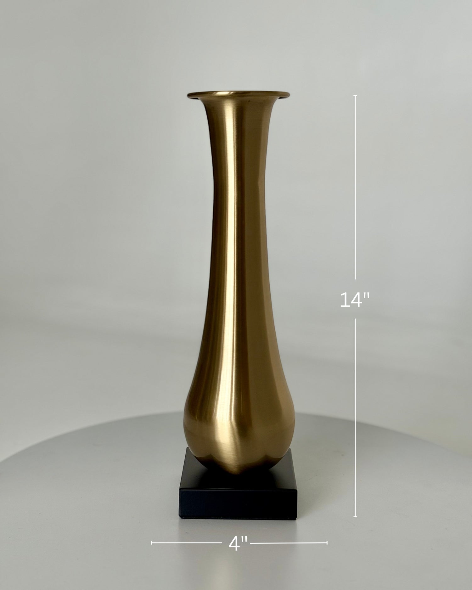High Objects Eterna Gold Vase, 14-inch tall brushed gold metallic vase with a flared opening on a black square base.