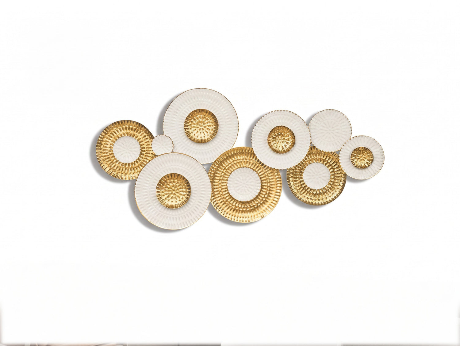 High Objects decorative wall art featuring a cluster of circular white and gold textured metal plates.