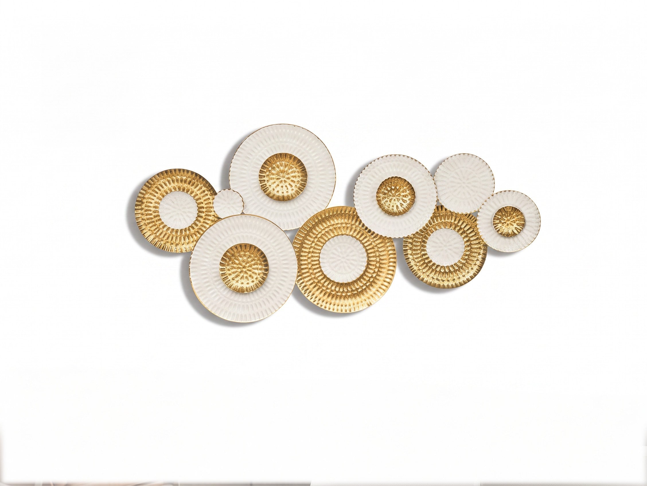 High Objects decorative wall art featuring a cluster of circular white and gold textured metal plates.
