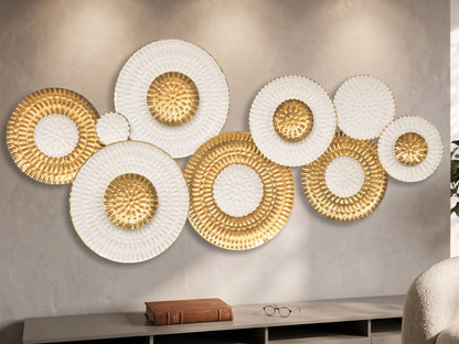 High Objects decorative wall art featuring a cluster of circular white and gold textured metal plates on a beige wall.