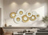 High Objects modern wall art featuring a cluster of white and gold textured circular metal discs in a living room.