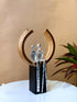 High Objects Golden Arc of Love showpiece, abstract couple in hammered silver finish within a gold ring on a black base.
