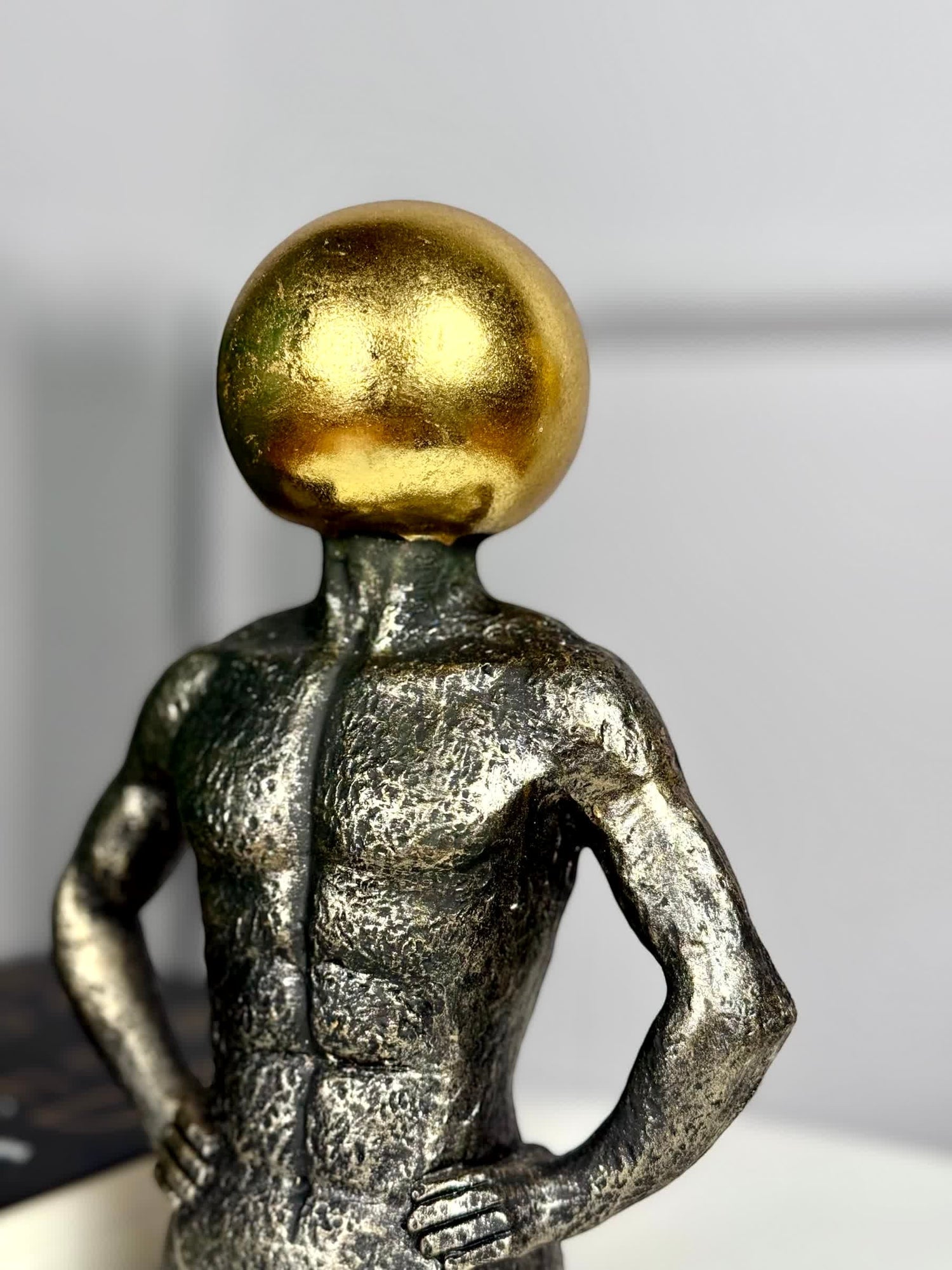 High Objects Golden Mind showpiece, a 9-inch polyresin sculpture of a muscular torso with a textured black finish and a gleaming golden orb head.