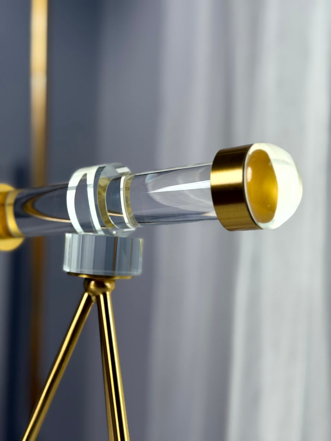 High Objects Golden Navigator Artefact, a modern acrylic and gold telescope-inspired décor piece on a tripod base.