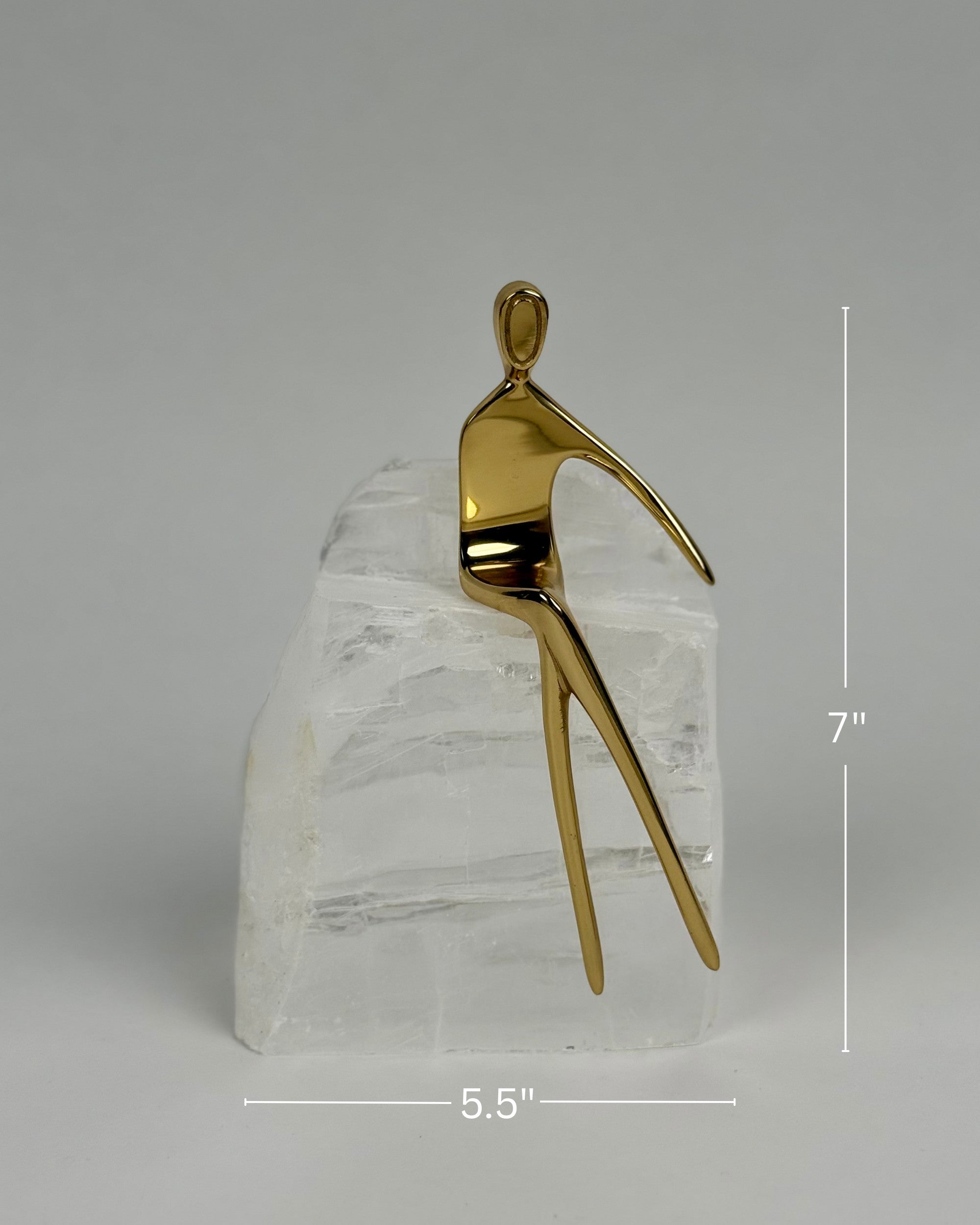 High Objects Golden Poise abstract sculpture of a seated figure on a natural crystal base, gold-finished iron.