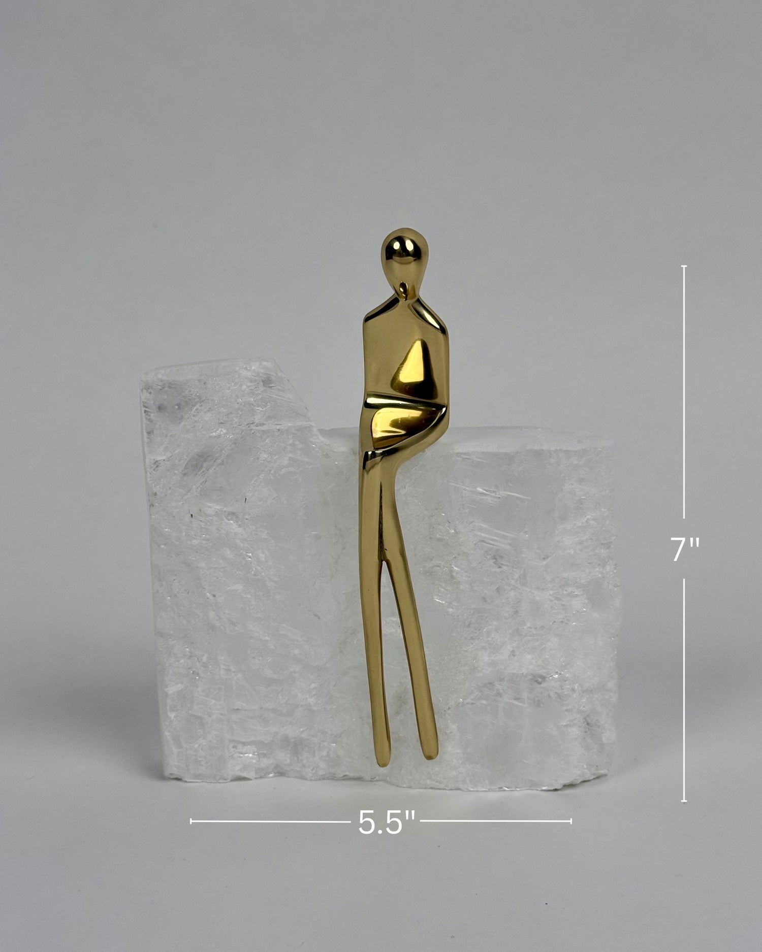 High Objects Golden Poise abstract sculpture of a figure in polished gold-finished iron on a natural crystal base.