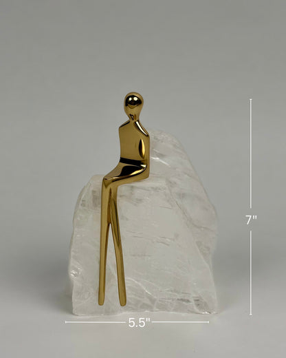 High Objects Golden Poise abstract figure sculpture on a natural crystal base, polished gold-finished iron.