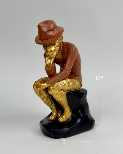 High Objects Golden Thinker showpiece, a monkey philosopher in a metallic gold suit and brown fedora, sitting on a black base.