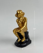 High Objects Golden Thinker Showpiece, a gold polyresin monkey in a thoughtful pose wearing a fedora on a black base.