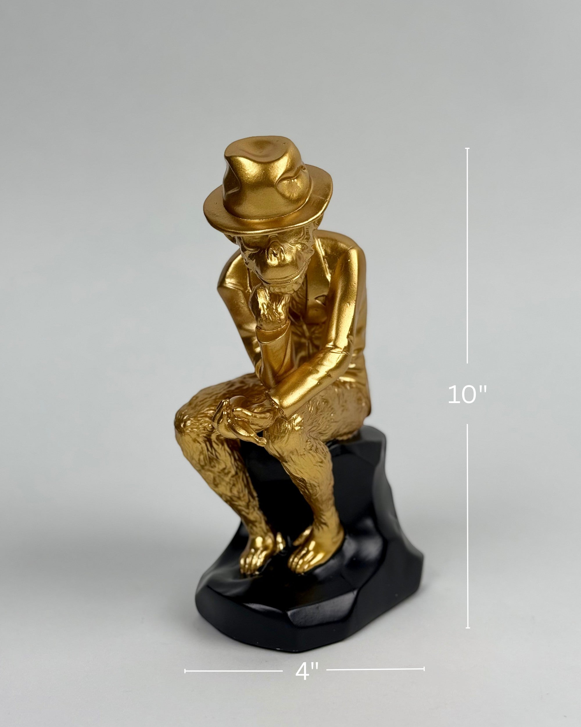High Objects Golden Thinker Showpiece, a gold polyresin monkey in a thoughtful pose wearing a fedora on a black base.