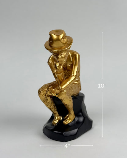 High Objects Golden Thinker Showpiece, a gold polyresin monkey in a thoughtful pose wearing a fedora on a black base.