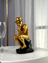 High Objects Golden Thinker showpiece, a monkey in a fedora and gold suit sitting thoughtfully on a black base.