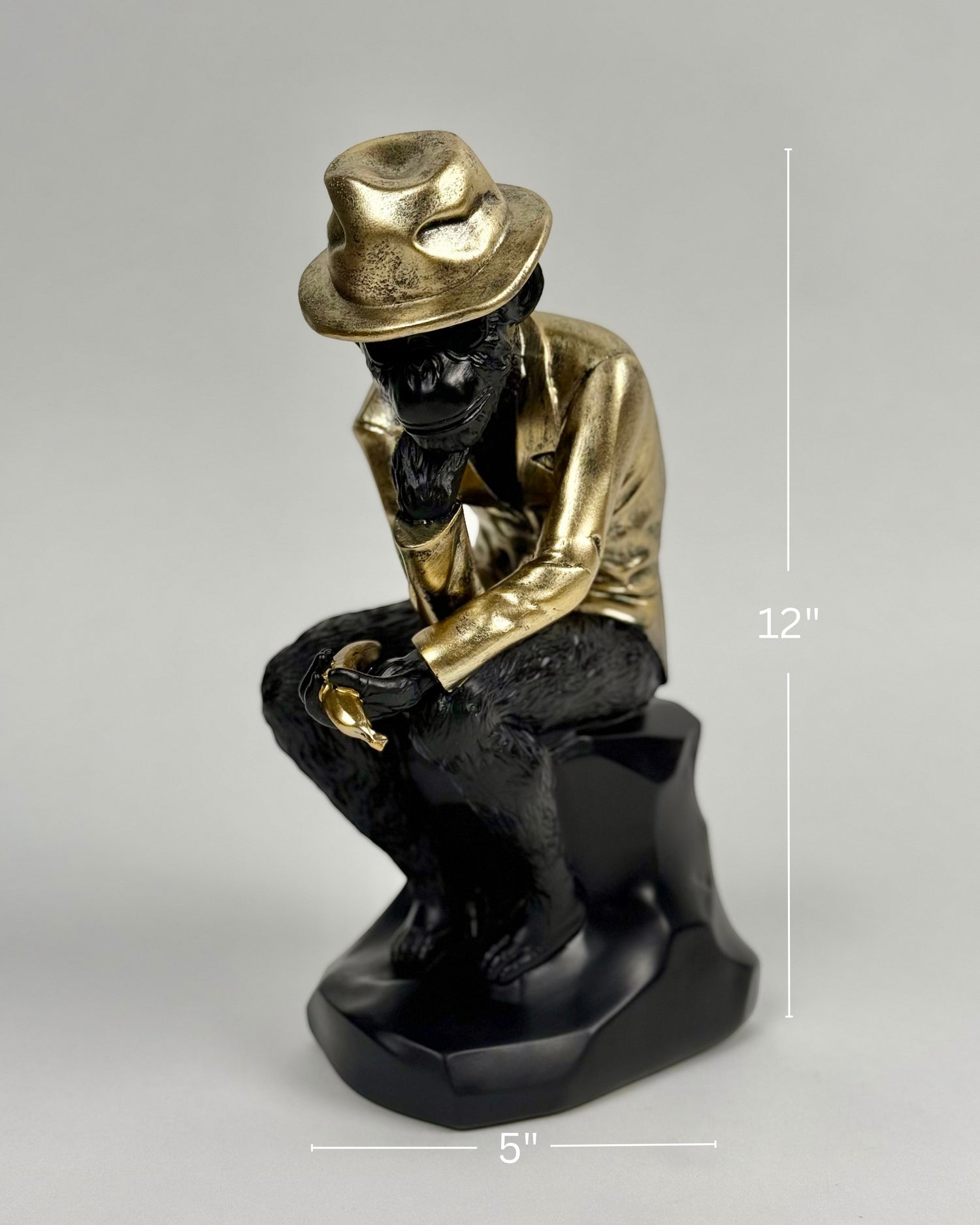 High Objects Golden Thinker showpiece, a monkey in a metallic gold suit and fedora, sitting in a thoughtful pose on a black base.