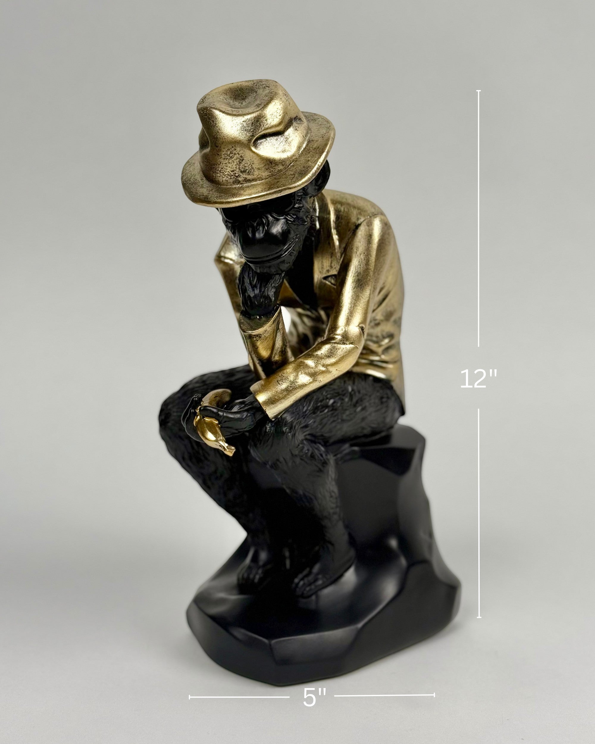 High Objects Golden Thinker showpiece, a monkey in a metallic gold suit and fedora, sitting in a thoughtful pose on a black base.