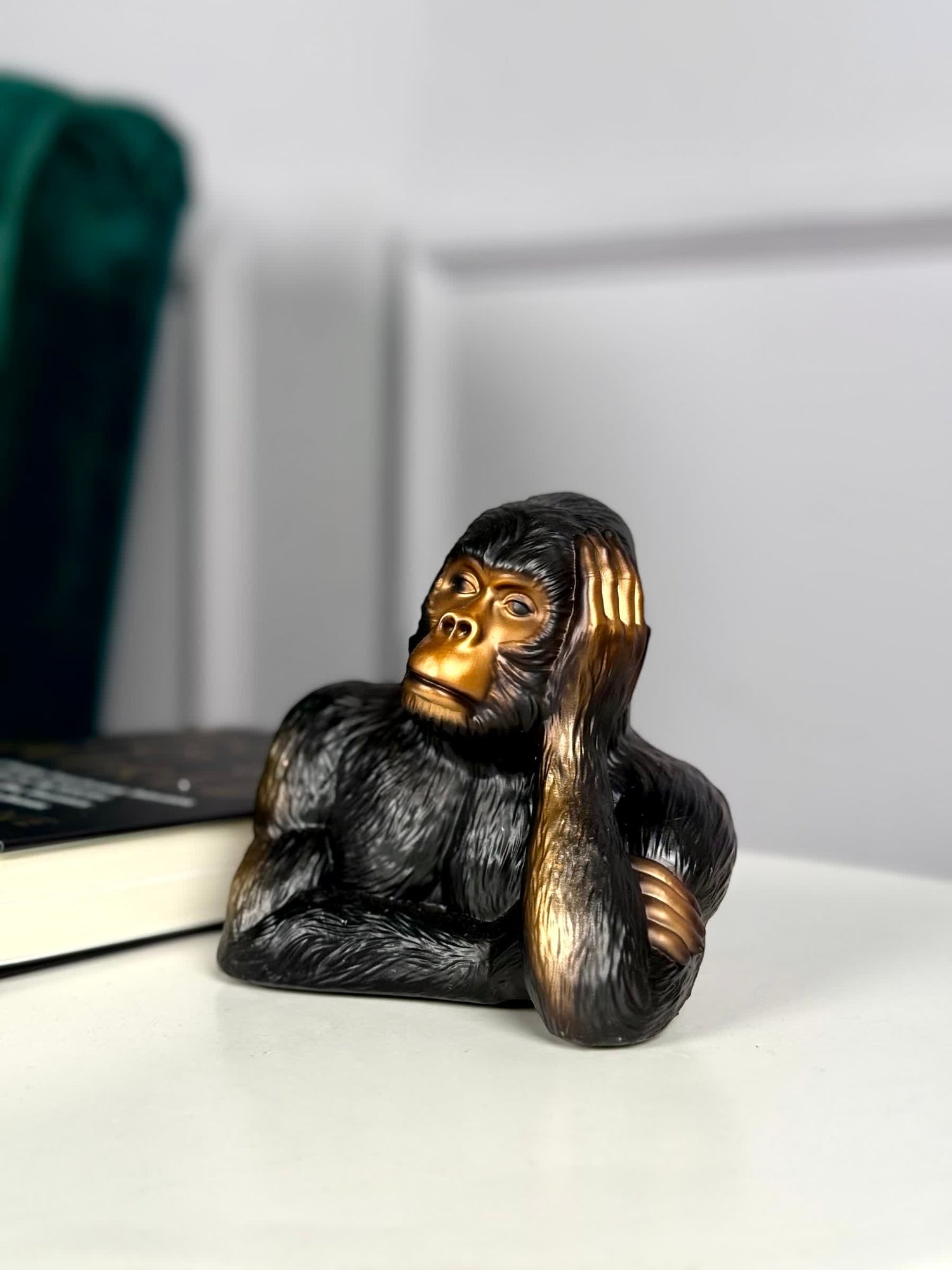 High Objects Pensive Gorilla showpiece, black polyresin with a striking gold face, resting head on hand.