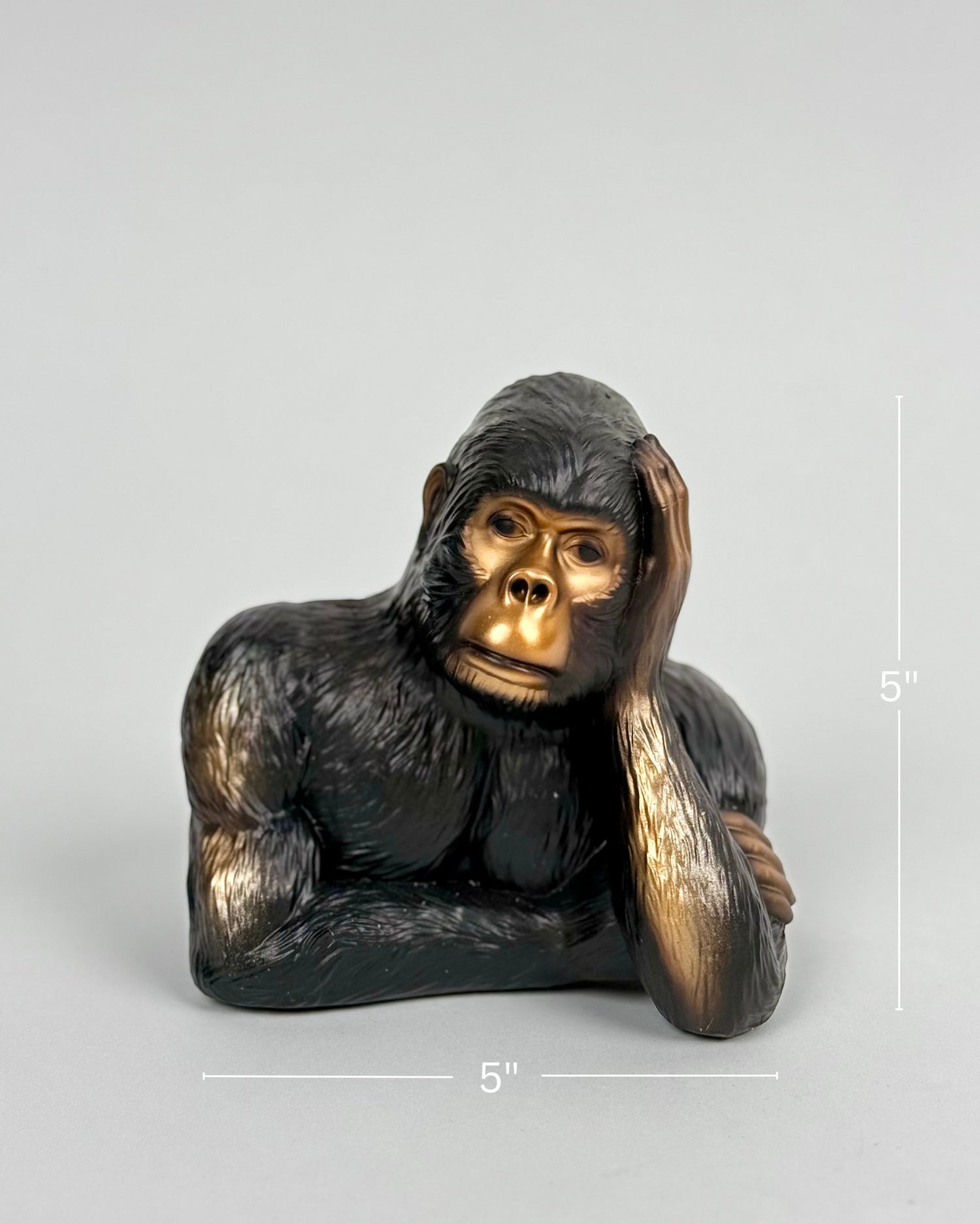 High Objects Pensive Gorilla Showpiece, dark brown polyresin sculpture with gold face, resting head on hand.