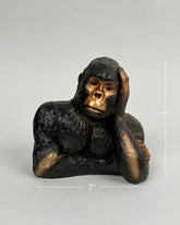 High Objects Pensive Gorilla showpiece sculpture with a golden face and dark textured body, resting head on hand.
