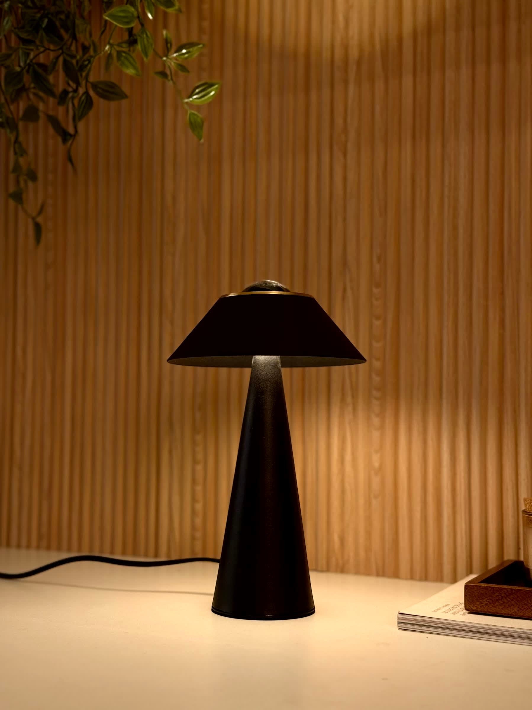 High Objects Halo Noir Table Lamp, matte black conical base with gold accent, flared shade, modern minimalist design.