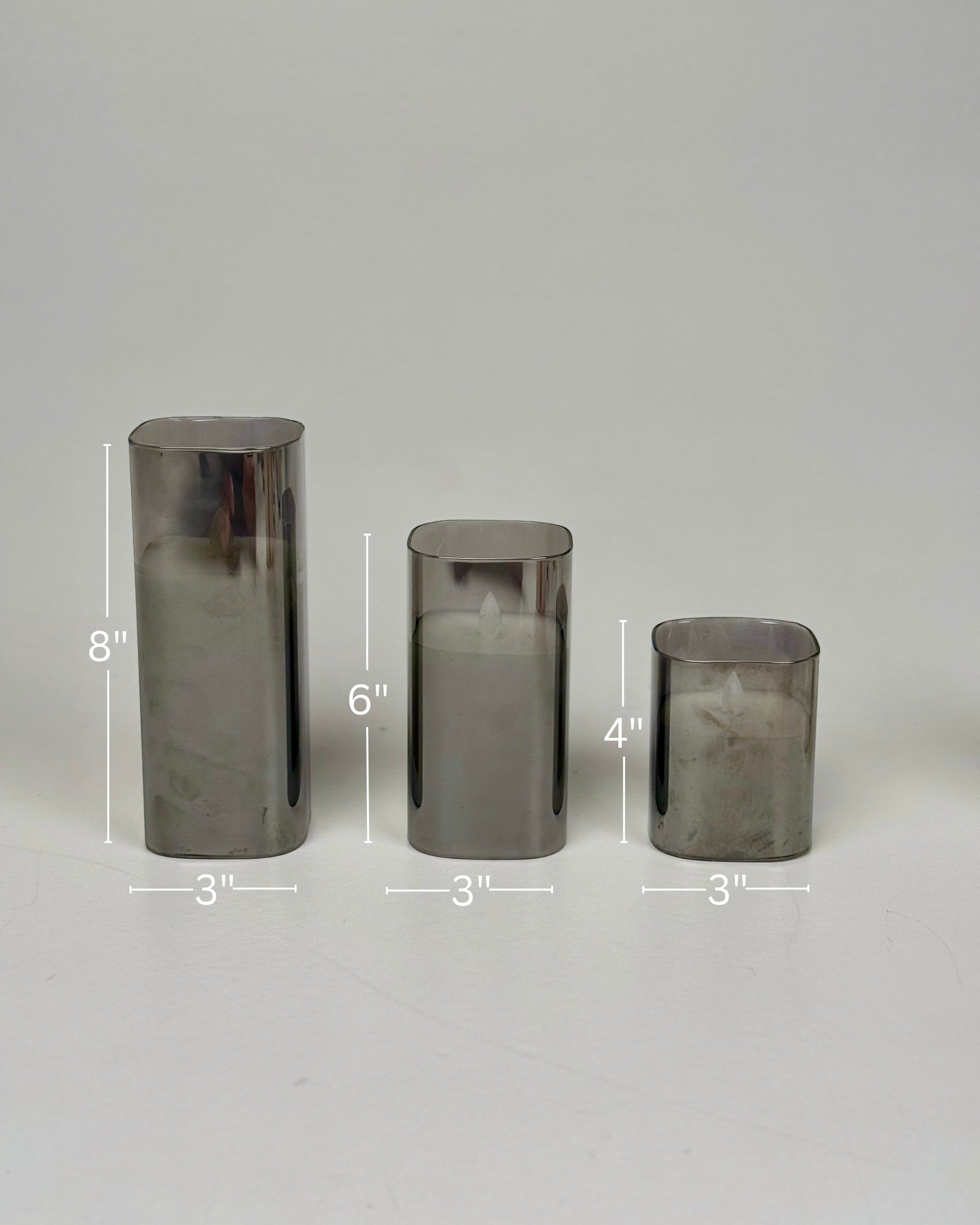 High Objects Halomist LED Candle Collection in smoked glass, set of 3 varying heights, modern design.