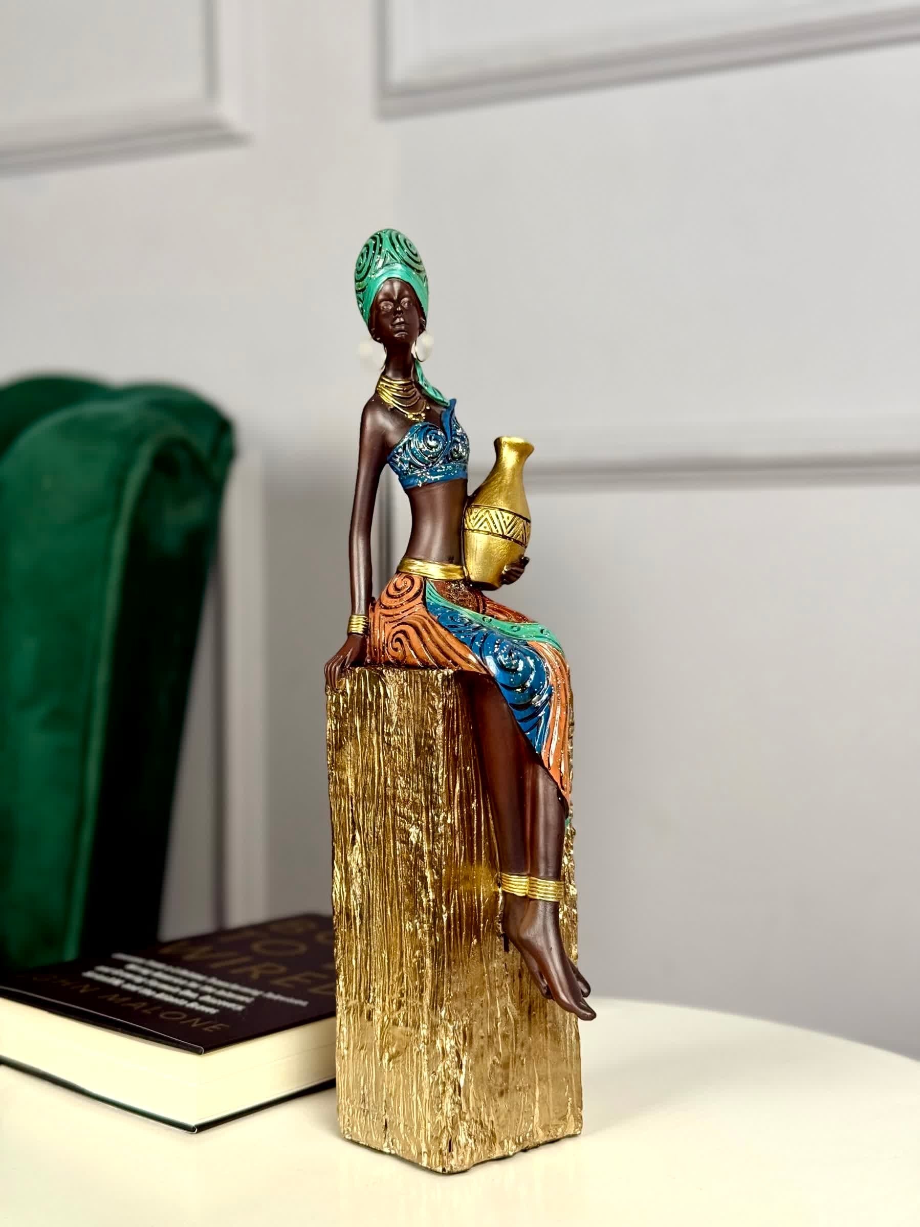 High Objects Heritage Grace showpiece: tribal woman in colorful attire holding a gold pot, made of polyresin.