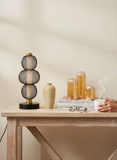 High Objects Complete Home Ambience Decor Set: black mesh lamp, beige vase, potted plant, and amber glass candle holders on magazines.