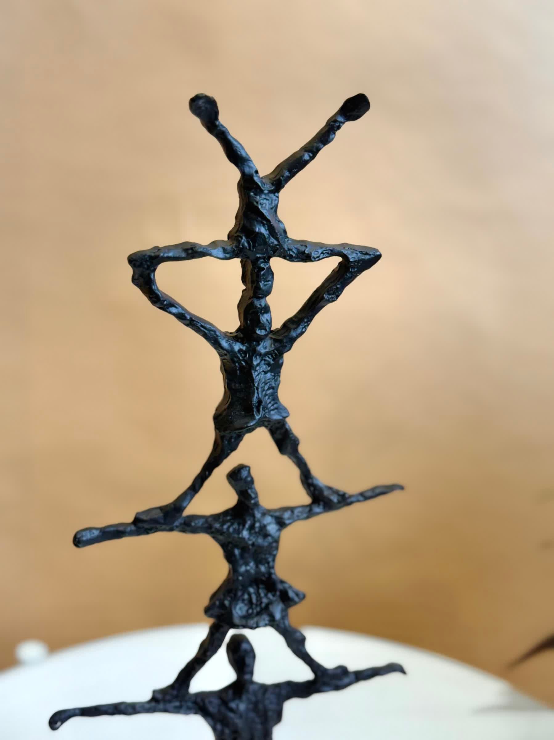 High Objects black textured abstract human pyramid artefact sculpture, 14.5 inches tall, symbolizing unity and strength.