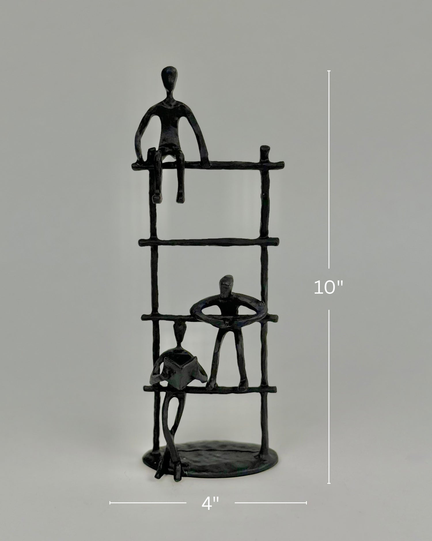 High Objects Journey Ladder Artefact figurine, matte black iron, 10" tall, abstract figures symbolizing progress and support.