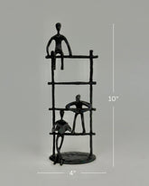 High Objects Journey Ladder Artefact figurine, matte black iron, 10" tall, abstract figures symbolizing progress and support.