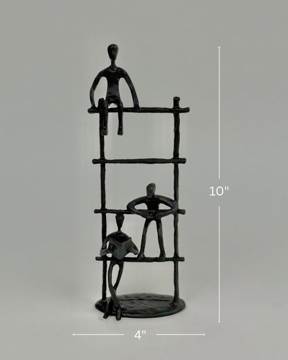High Objects Journey Ladder Artefact figurine, matte black iron, 10" tall, abstract figures symbolizing progress and support.