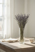 High Objects Lavande Still dried lavender stems in a clear glass vase on a wooden table.
