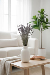 High Objects Lavande Still dried lavender stems in a matte ivory ceramic vase on a wooden table.