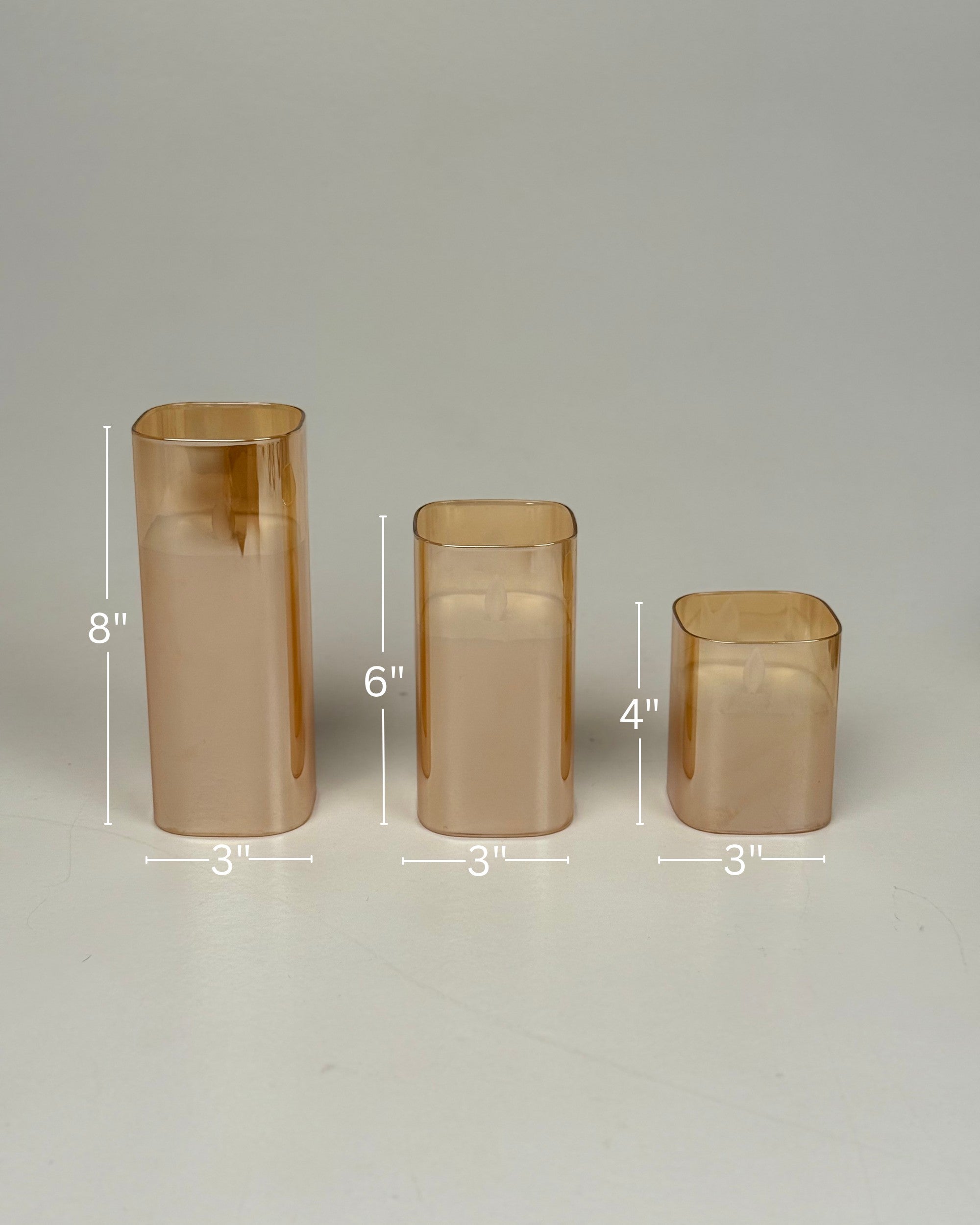 High Objects Halomist LED Candle Collection in amber glass, set of 3 varying heights, modern design.