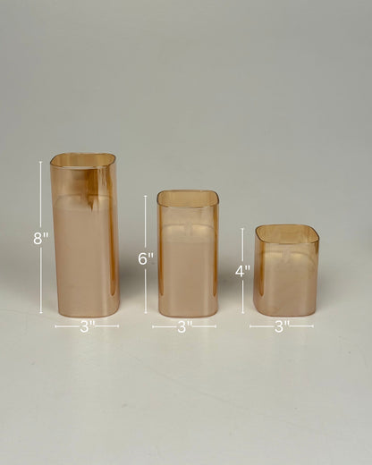 High Objects Halomist LED Candle Collection in amber glass, set of 3 varying heights, modern design.