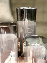 High Objects Halomist LED candles in tinted glass shells with flickering LED flames, modern design.