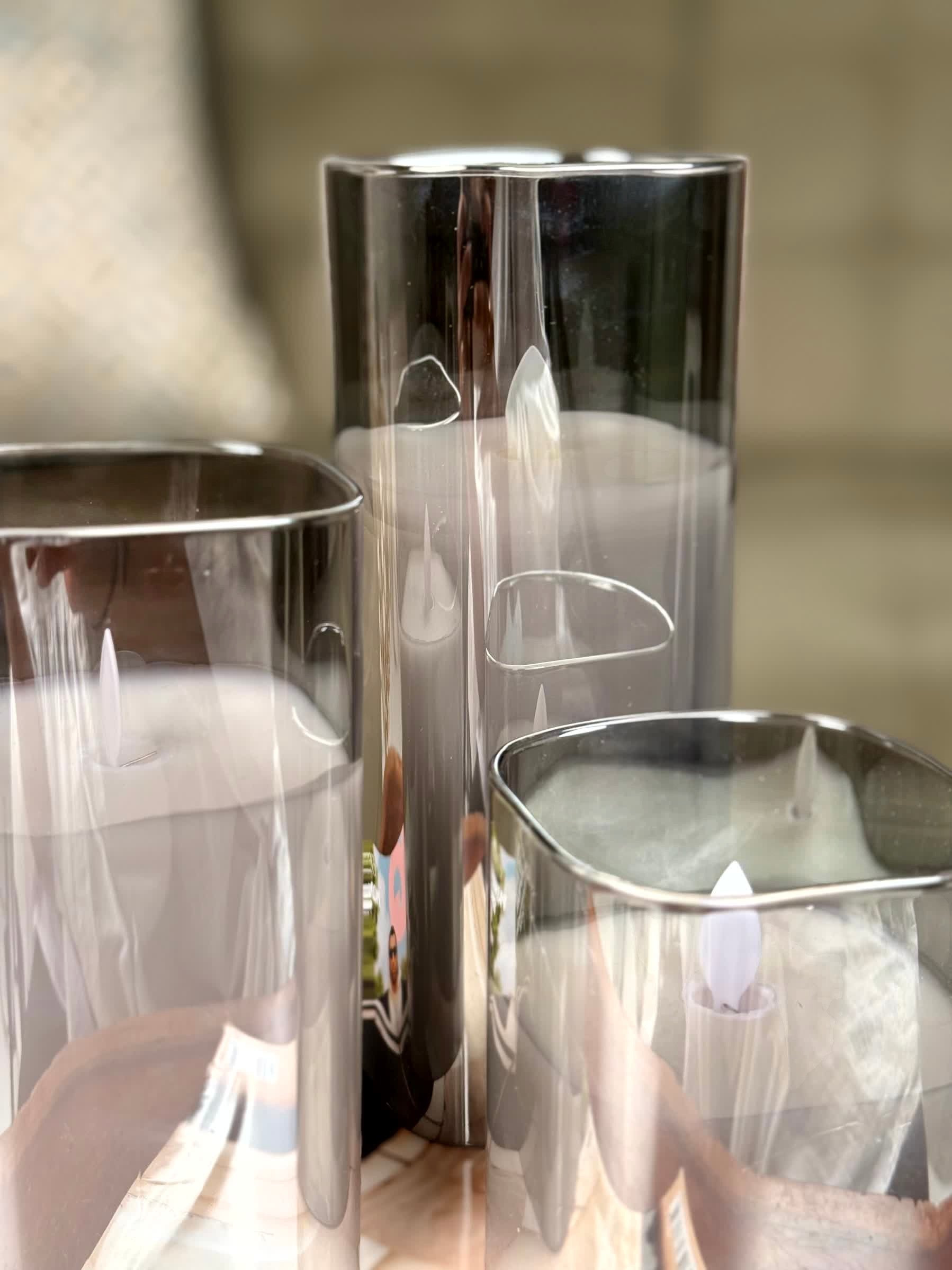 High Objects Halomist LED candles in tinted glass shells with flickering LED flames, modern design.