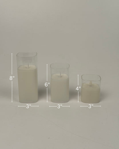 High Objects Halomist LED Candle Collection: Set of 3 ivory pillar candles with clear glass casings, in 8", 6", and 4" heights.
