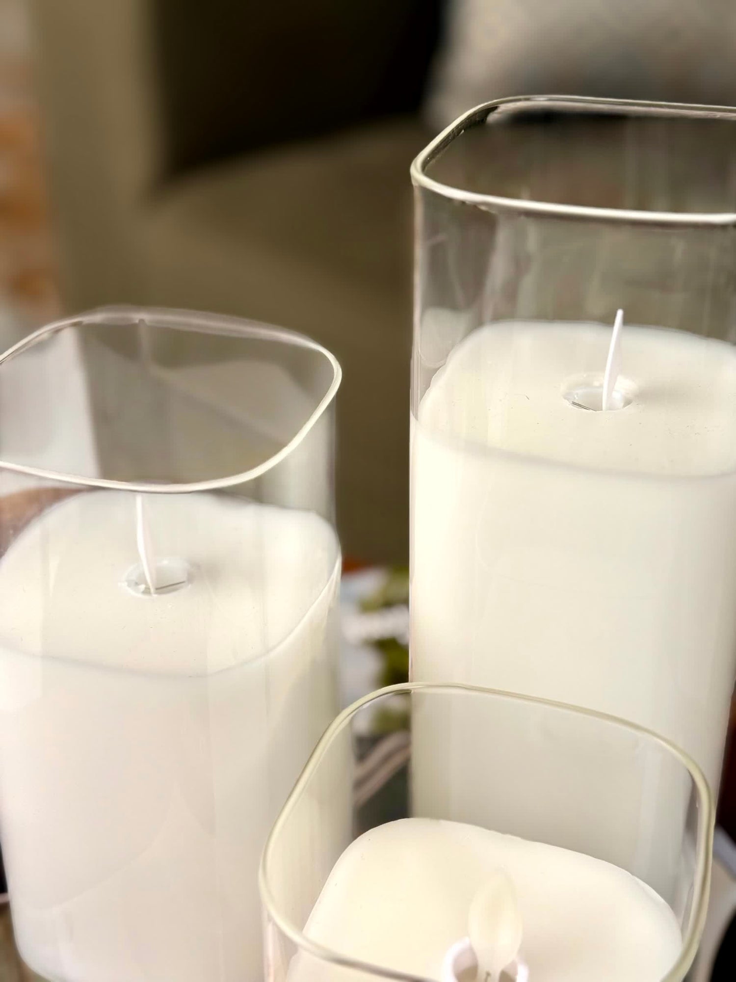 High Objects Halomist LED candles in white wax with clear glass cylinders, featuring modern rounded square and cylindrical shapes.