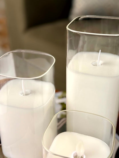 High Objects Halomist LED candles in white wax with clear glass cylinders, featuring modern rounded square and cylindrical shapes.