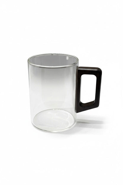 High Objects LINEA glass cup with a squared dark wood handle. Clear cylindrical glass body, heat-resistant.