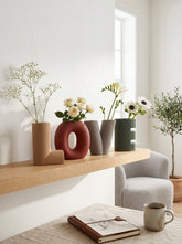 High Objects set of 4 decorative vases in the shape of the word LOVE. Colors: tan, burgundy, grey, and green.