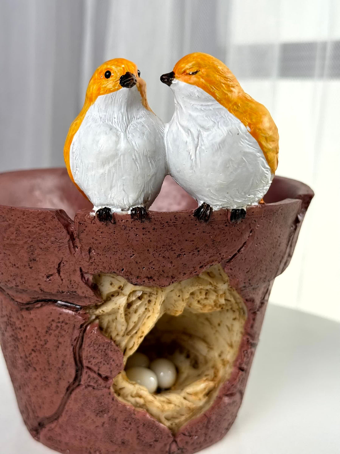 High Objects Lovebird Planter Showpiece, polyresin planter with cracked pot design, two yellow and white lovebirds on rim, nest with eggs inside.